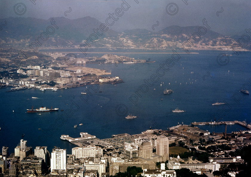 PMR.HK-16 
 Hong Kong 1958: view from the summit of Mount Victoria with the Star Ferry terminal, Hong Kong and Shanghai Bank building (right centre) and airport runway jutting out into the harbour. 
 Keywords: British colonies, nostalgia, historic, island, tropics, Far East