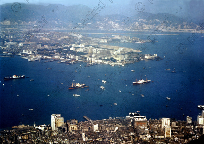 PMR.HK-15 
 Hong Kong 1958: view from the summit of Mount Victoria with airport runway, built out into the bay, in the background. 
 Keywords: British colonies, Far East, tropics, island, historic, nostalgia
